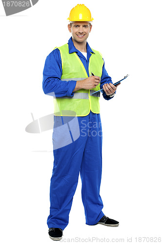 Image of Male architect signing business documents