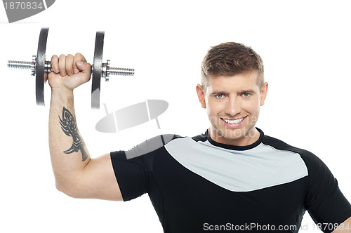 Image of Male instructor posing with raised dumbbell