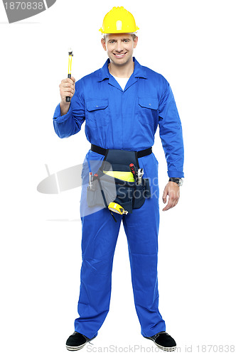 Image of Industrial contractor holding hammer. Full length shot