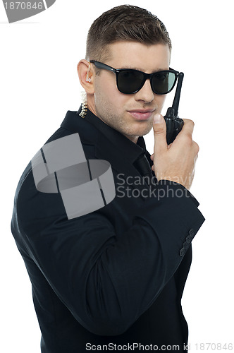 Image of Chief security officer communicating through his walkie-talkie