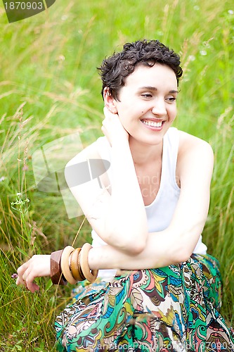 Image of  girl resting on fresh spring grass 
