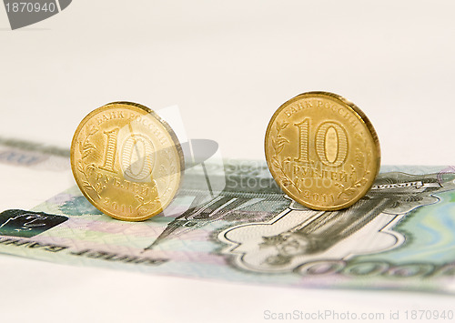 Image of Two coins on banknote