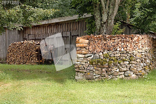 Image of woodpile on stone wall