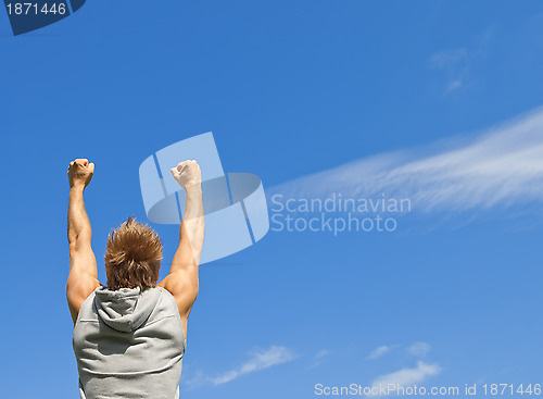 Image of Sporty guy with his arms raised in joy