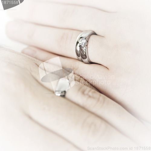 Image of Hands wearing wedding rings