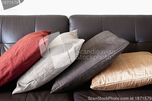 Image of Cushions on leather sofa