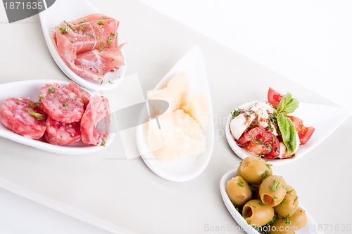 Image of deliscious antipasti plate with parma parmesan and olives