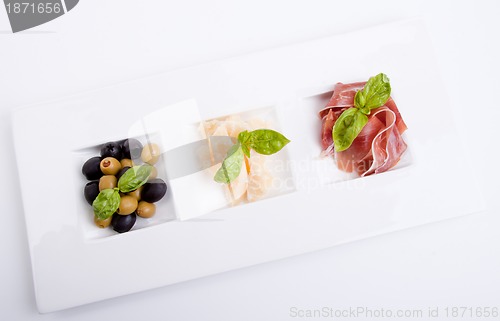 Image of deliscious antipasti plate with parma parmesan and olives