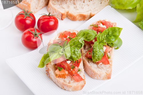 Image of deliscious fresh bruschetta appetizer with tomatoes isolated