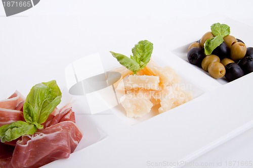 Image of deliscious antipasti plate with parma parmesan and olives