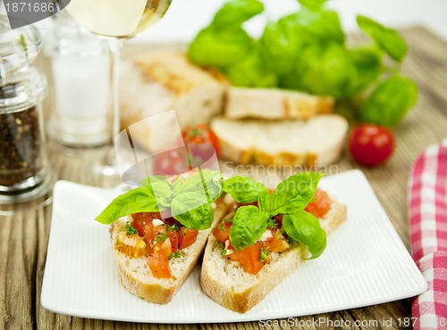 Image of fresh tasty italian bruschetta with tomato on table