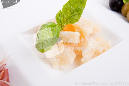 Image of deliscious antipasti plate with parma parmesan and olives