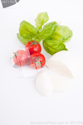 Image of tasty tomatoe mozzarella salad with basil on white 