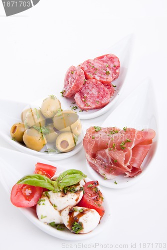 Image of deliscious antipasti plate with parma parmesan and olives
