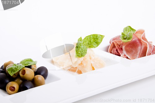 Image of deliscious antipasti plate with parma parmesan and olives