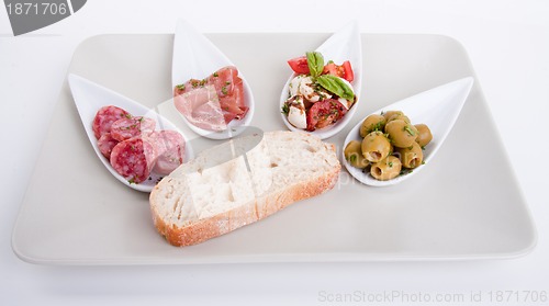 Image of deliscious antipasti plate with parma parmesan and olives