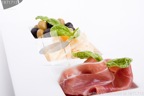 Image of deliscious antipasti plate with parma parmesan and olives