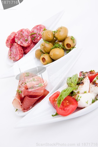 Image of deliscious antipasti plate with parma parmesan and olives