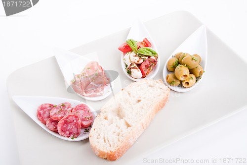 Image of deliscious antipasti plate with parma parmesan and olives