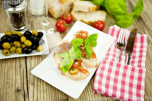 Image of fresh tasty italian bruschetta with tomato on table