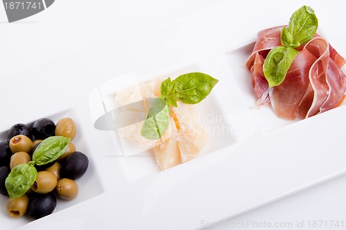 Image of deliscious antipasti plate with parma parmesan and olives