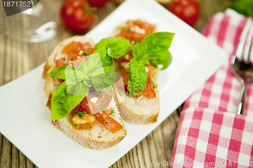 Image of fresh tasty italian bruschetta with tomato on table