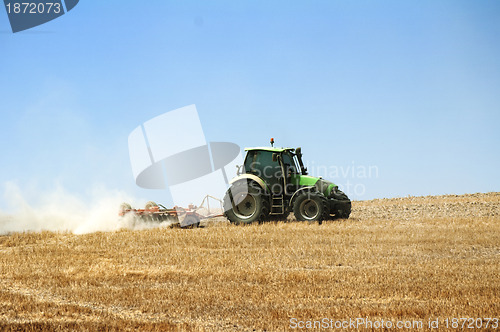 Image of Tractor plowing field