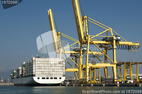 Image of Freighter in port being loaded with containers