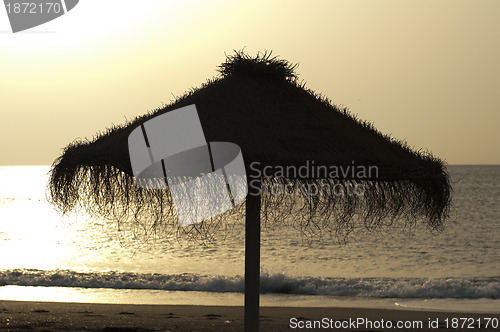 Image of Straw umbrella on sunrize 