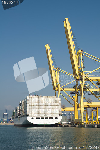 Image of Freighter in port being loaded with containers