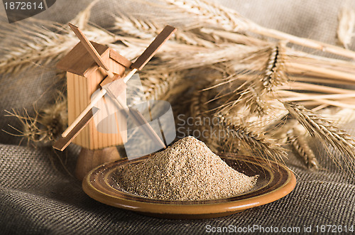 Image of Wholemeal flour and wheat on cloth sack, close-up