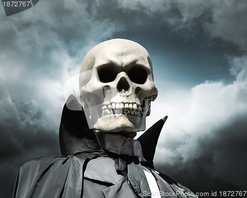 Image of grim reaper. death's skeleton on a cloudy dramatic sky