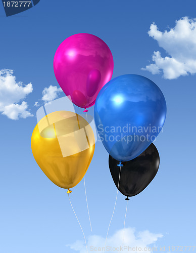 Image of CMYK colored balloons on a blue sky