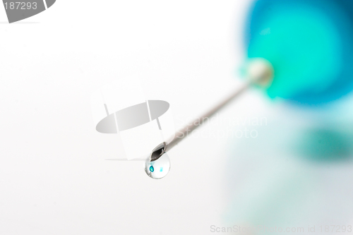 Image of Drop of blue liquid on an injection needle