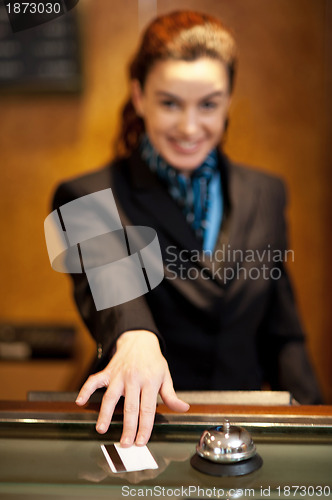 Image of Lady returning the cash card to the customer