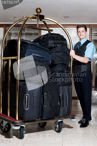 Image of Concierge with a pile of bags in luggage cart