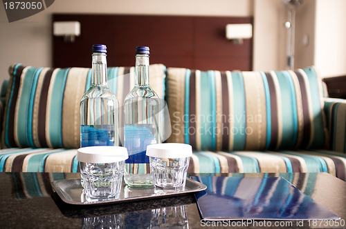 Image of Hotel room shot. Beverage bottles in focus