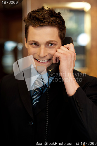 Image of Well dressed gentleman attending phone call