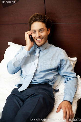 Image of Businessman attending personal calls after work