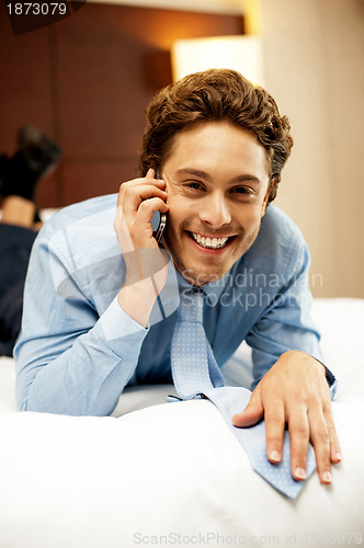 Image of Relaxed young businessman communicating with his partner