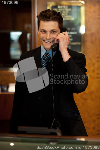 Image of Calm and relaxed executive interacting over the phone