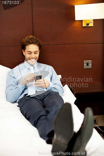 Image of Handsome business executive surfing his mobile