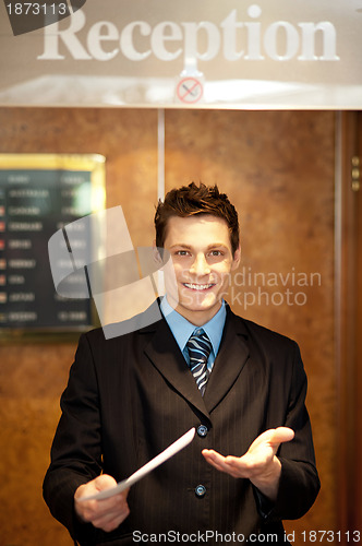 Image of Young man holding an invoice