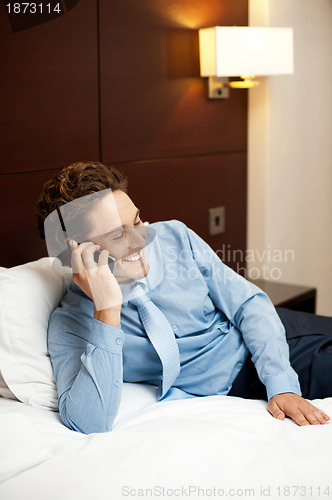 Image of Delighted young man communicating with his partner