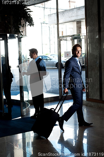 Image of Caucasian guest walking towards the reception