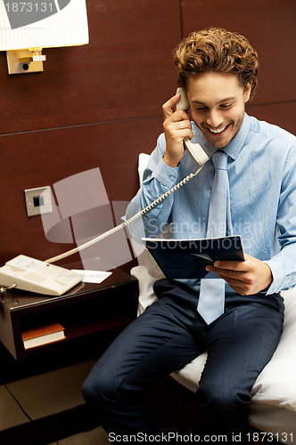 Image of Smiling gentleman placing an order over the phone