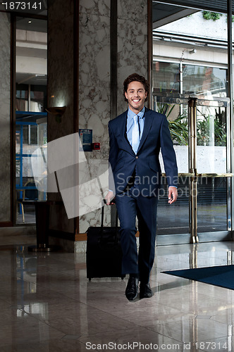 Image of Business executive entering hotel lobby
