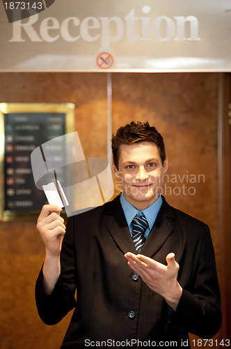 Image of Snap shot of handsome guy holding cash card
