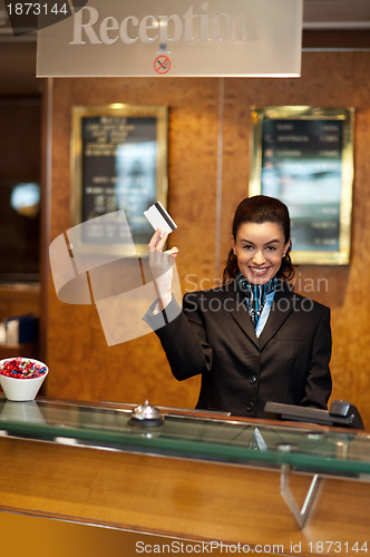 Image of Beautiful receptionist posing with customers cash card