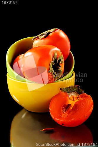 Image of Persimmon fruits in a bowl.